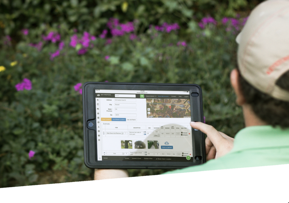 Ipad with singleops software being shown in front of flowering bush